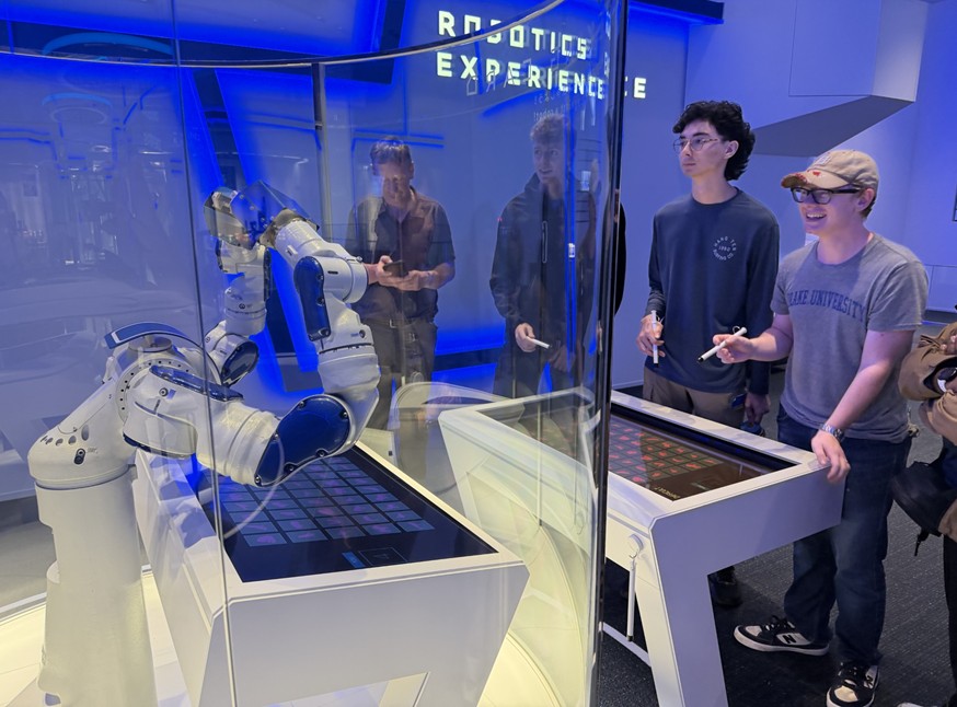 robots CS students using styluses to control a display robot in Japan.